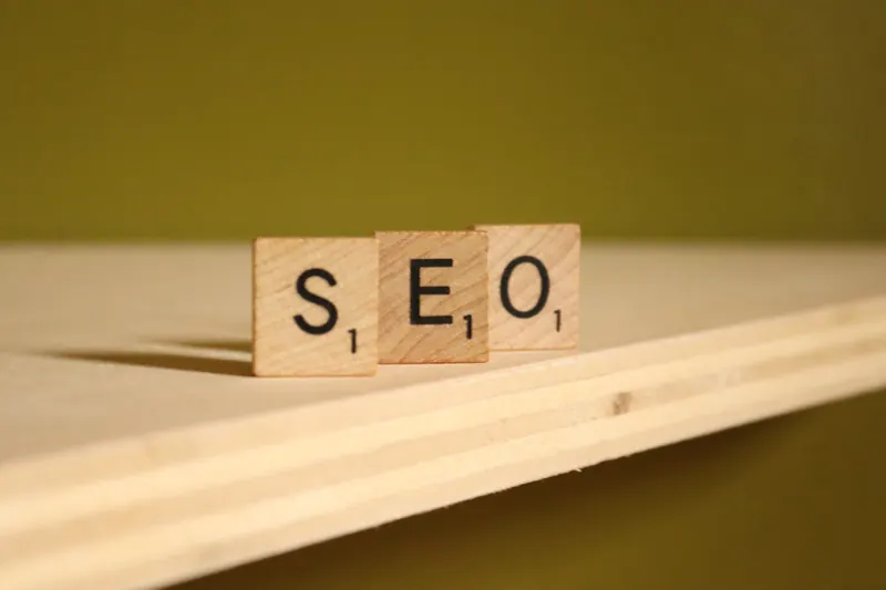 Wooden letter tiles spelling out SEO on a plank of wood