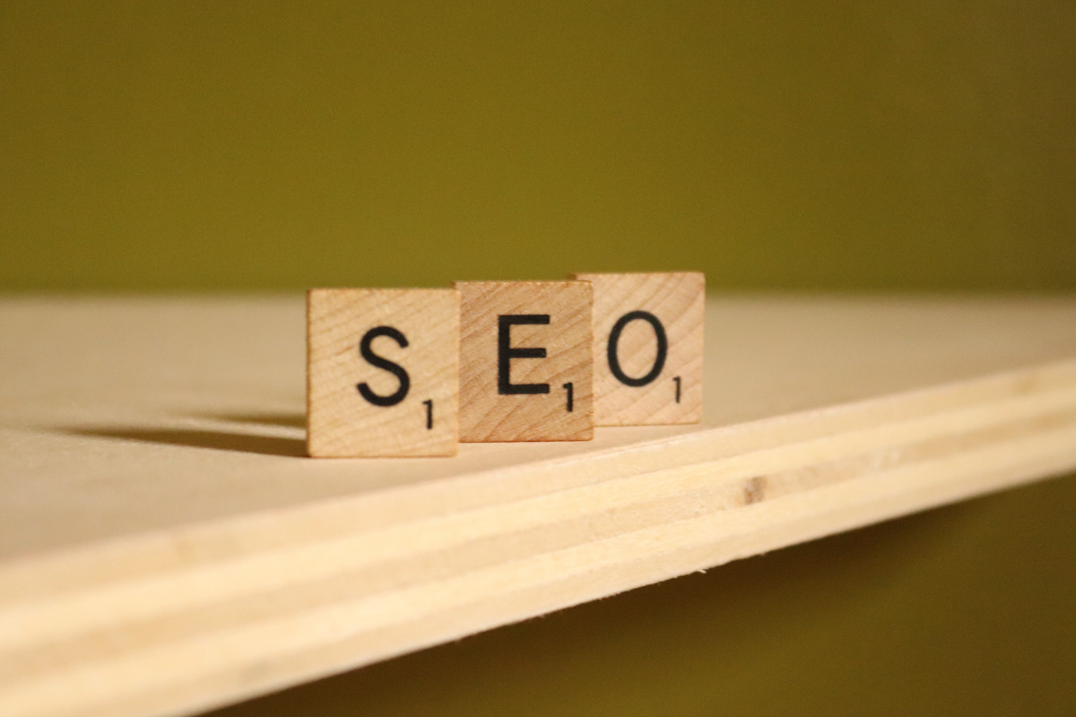 Wooden letter tiles spelling out SEO on a plank of wood