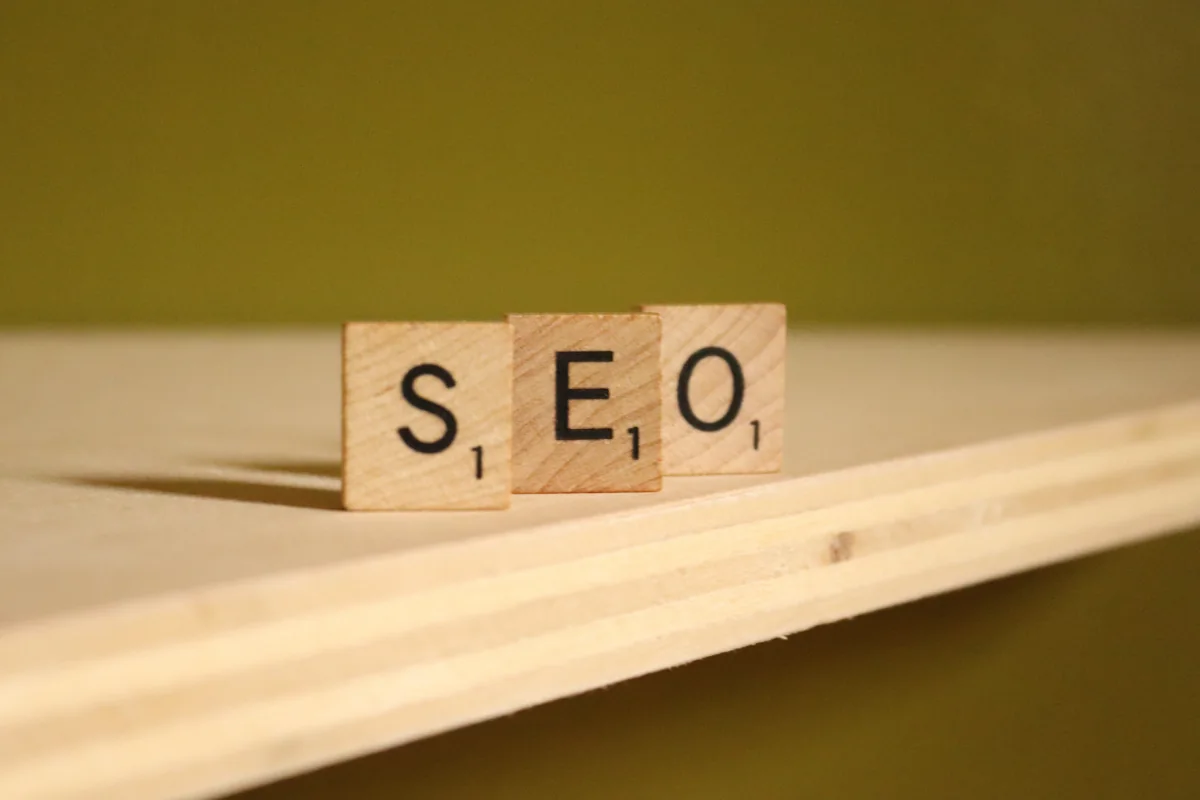 Wooden letter tiles spelling out SEO on a plank of wood